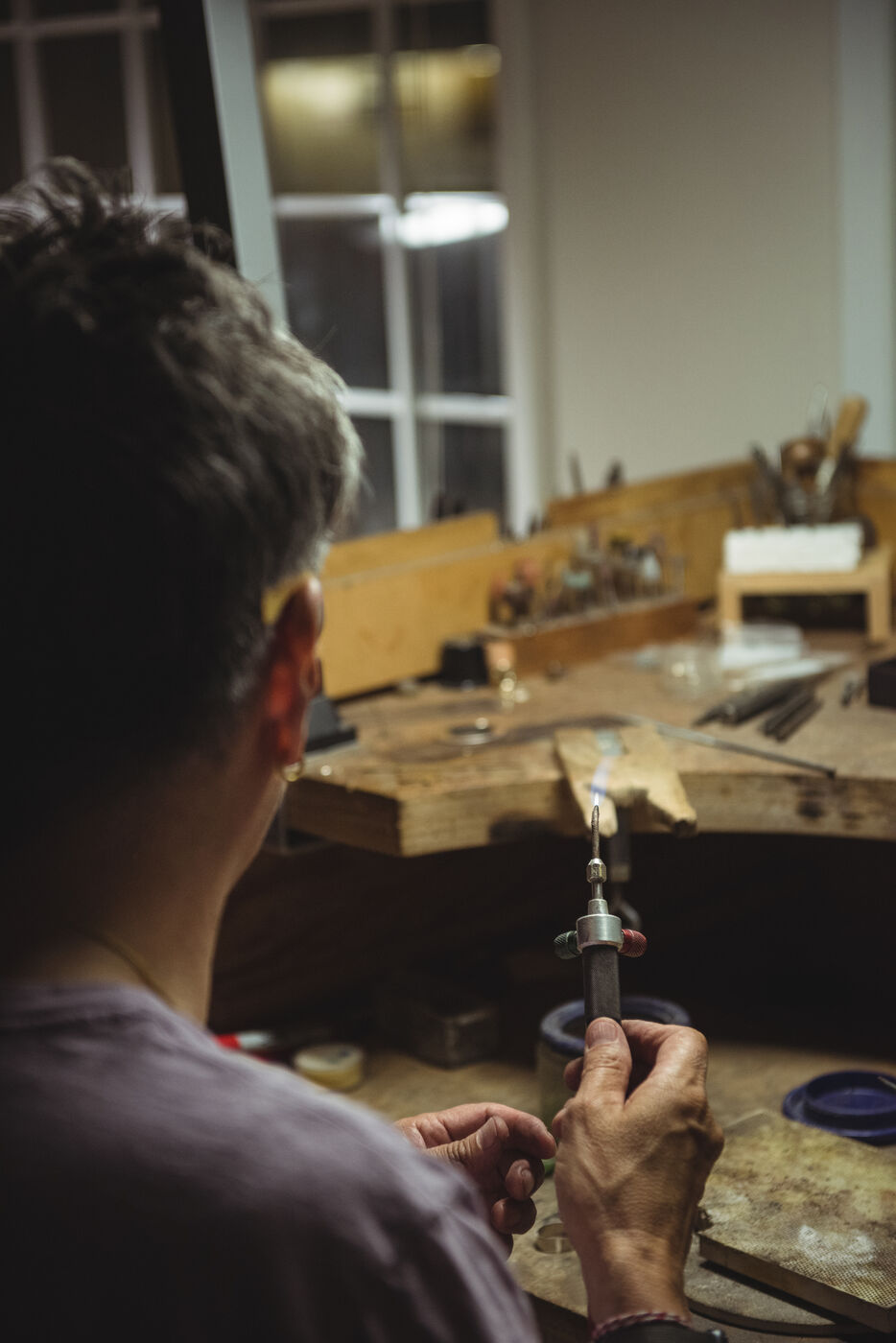 Golden Vista craftsperson working with a torch at the bench